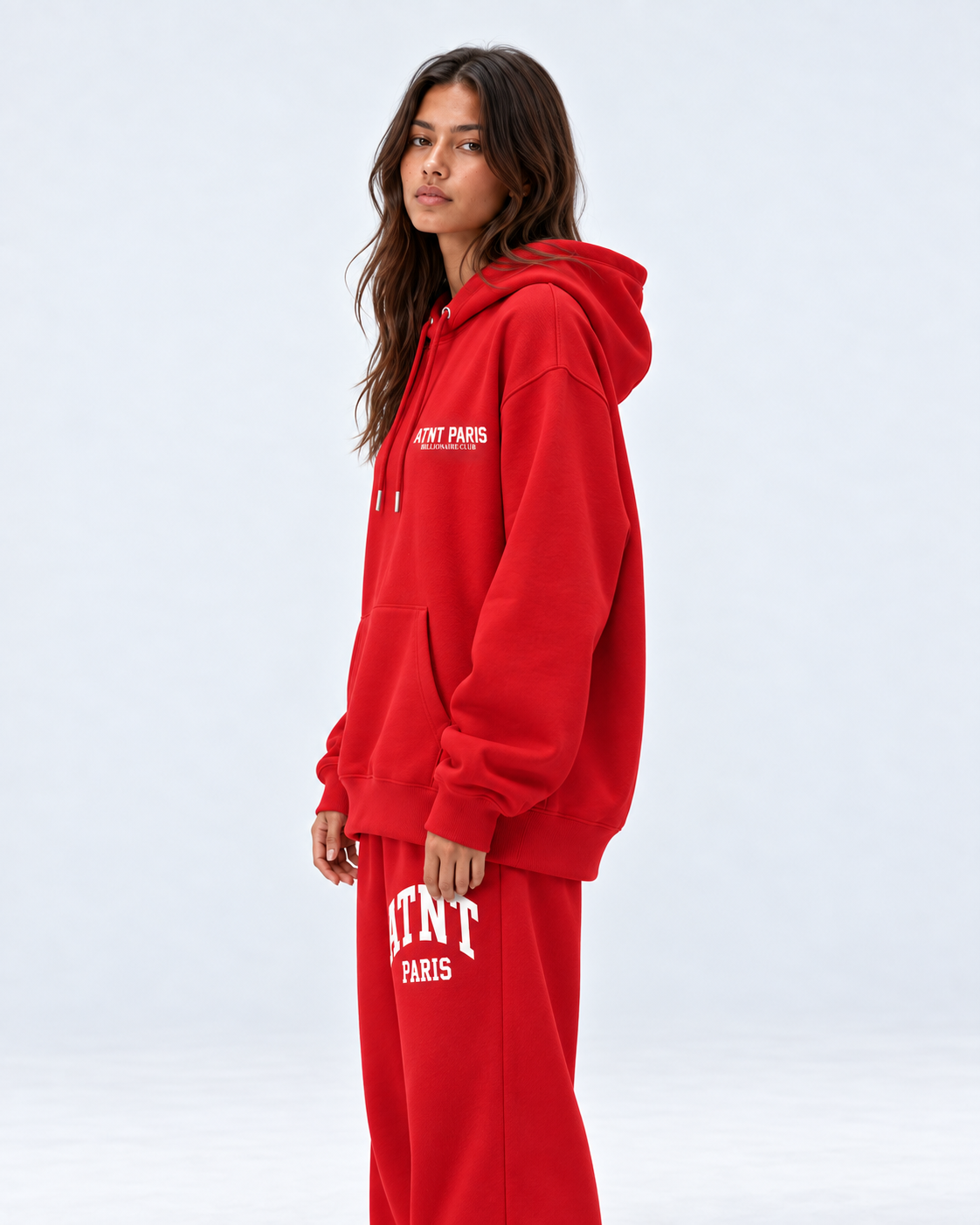 Sweat Billionaire Club rouge ATNT PARIS — porte profil, coupe portée ample, studio gris clair