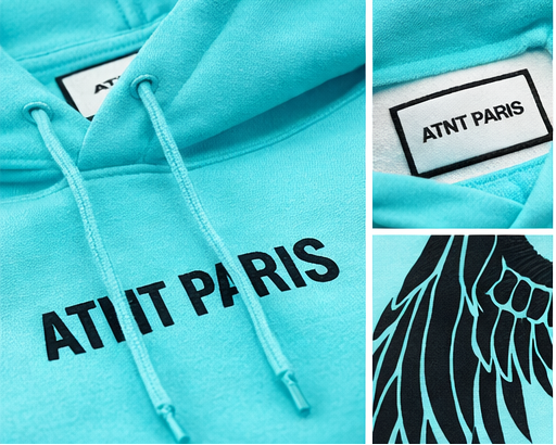 Détail du logo ATNT Paris brodé sur sweat bleu tiffany
 finition premium et matière épaisse