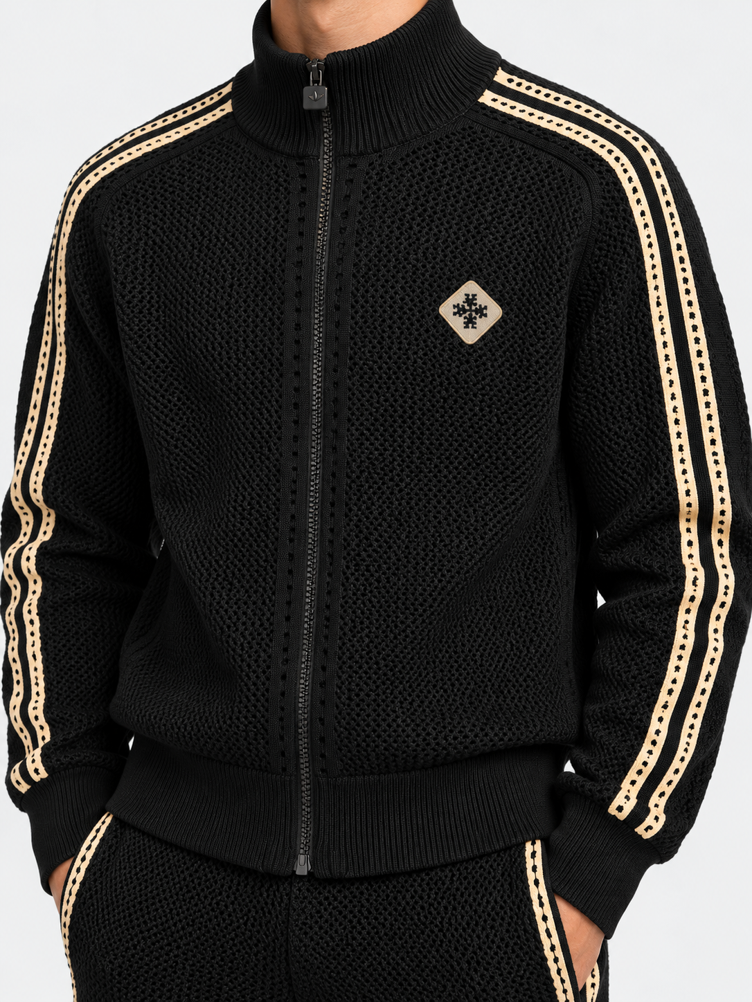 ATNT Tracksuits studio : Ensemble de Survêtement Signature Noir - Crochet, détail de la matière sur fond gris clair
